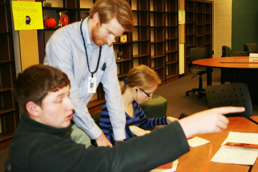 Interventionist Michael Lynch works with sophomores Brandon Miller and Miranda Moore after school in the Learning Commons during tutoring. The program is just one of several uses for the new space, formally known as the Media Center.