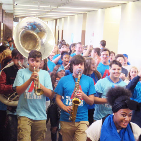 Students in A wing the blue team march through the halls with their band instruments creating a ruckus.