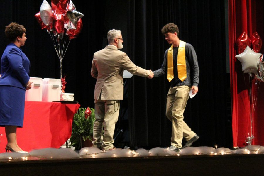 Principle Bill Ferrar shakes senior scholar Craig Lattys hand. Latty was also honored with Summa Cum Laude, Top 100, CTE Completer-Engineering, and CTE Completer - Arch Design. 