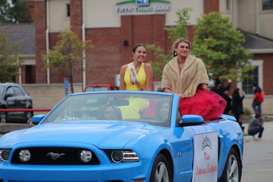 Seniors Madyson Drouillard and Antonina Anderson smile at the crowd during the parade. Drouillard was crowned princess and Anderson was crowned queen. Liam Brodie and Armando Flores were crowned prince and king. 
