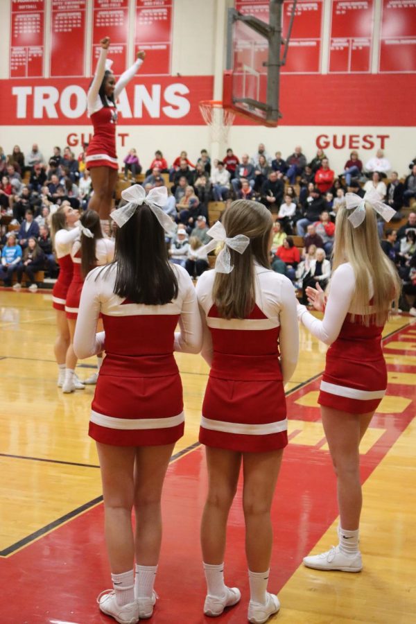 The varsity sideline cheer team performs a stunt during the boys varsity game. The captains of the team are seniors Isabella Petrangelo, Darby Klemz, and Abbie Fick.

