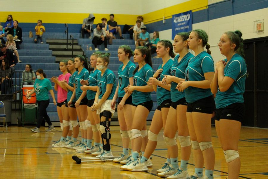 The MHS Varsity Volleyball team lines up before their Teal Attack match. The final score of the game was 3-1, with Monroe losing 3 of the sets.  