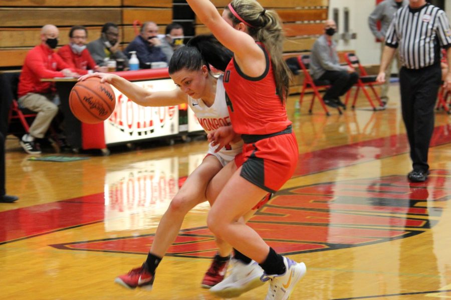 Senior Olivia Bussell pushes to get past a Bedford player on defense. Bussell has been playing on varsity since her freshman year.