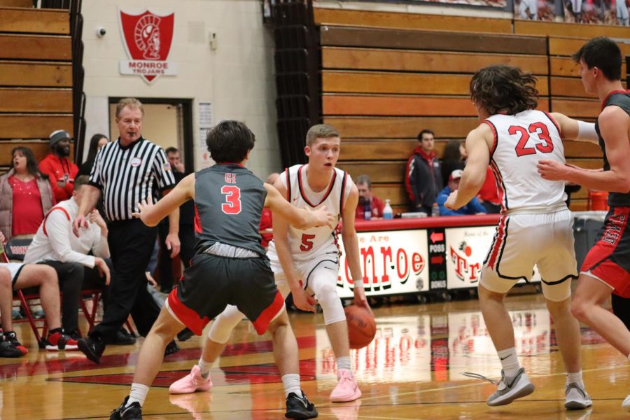 Senior Xander Middleton crosses the Grosse Ile player. Middleton is close to scoring his 1,000 point of his high school career.