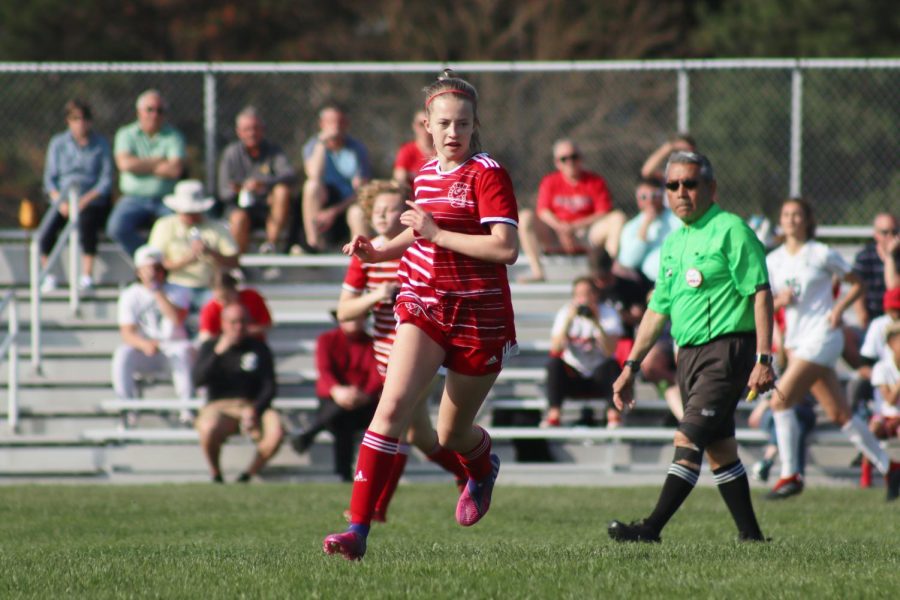 Sophomore Rebecca Pace runs up the field, following the action. Pace plays as a midfielder.