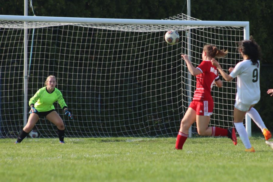Senior and goalie Ava Smith prepares to catch the ball, stopping the goal. Smith stopped several goals during the game.